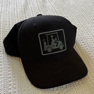 Travis Mathew Black Hat with Gray Golf Cart Patch